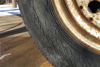 A boat trailer tire that is severly cracked on the sidewalls, also called "weather checked".
