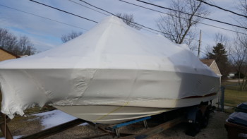 A Monterey 268ss sitting on a trailer and it has been winterized and shrink-wrapped to seal out the weather.