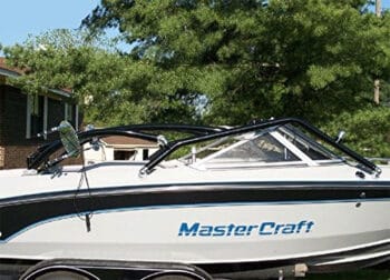 Wakeboaard tower folded down for storage on black and white boat